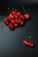 Spring red cherries on black background selective focus cherry