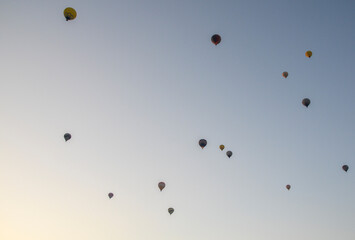 The sunrise in the mountains with Hot air balloons flying over Cappadocia red valley in the sky. Travel to Goreme, Turkey