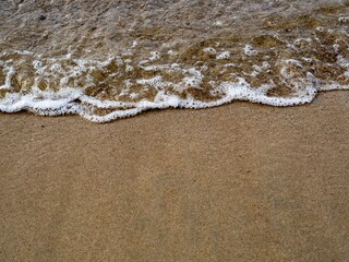 Soft wave of blue sea on sand beach, Background texture