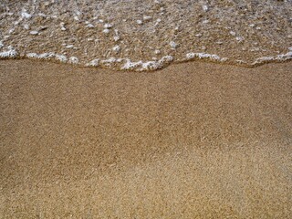 Soft wave of the sea on sand beach, Background texture