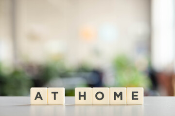 white cubes with at home lettering on white desk in office