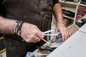 shoemaker man working in his shoe shop