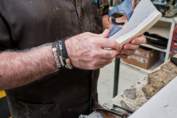 shoemaker man working in his shoe shop
