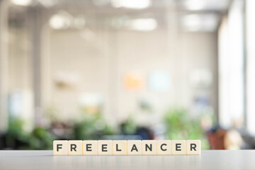 white cubes with freelancer lettering on white desk