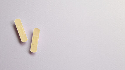Band aid on purple background. medical concept. simple, minimal