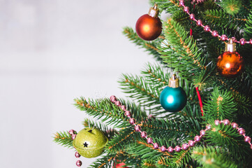 Christmas background - baubles and branch of artificial spruce tree