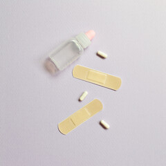 Band aid and Pills on purple background. medical concept. simple, minimal