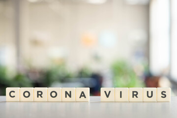 white cubes with corona virus lettering on white surface