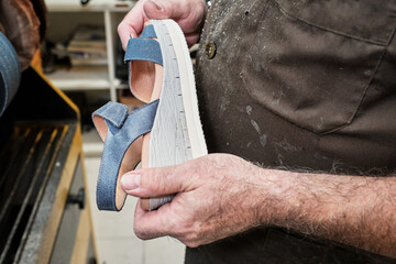 shoemaker man working in his shoe shop