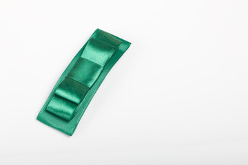 Hair clip made of green ribbon. On white background.
