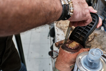 shoemaker man working in his shoe shop