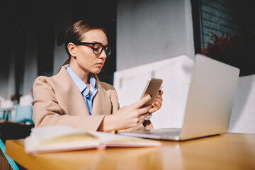 Emotional hipster girl surprised with winning online contest talking with operator on mobile phone