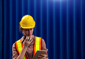 Female foreman is using walkie talkie