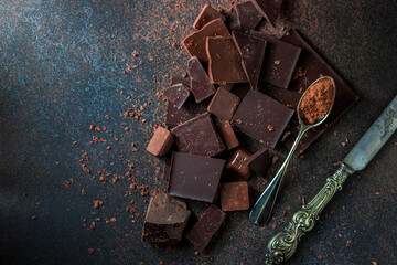 Dark and milk chocolate on a concrete background.