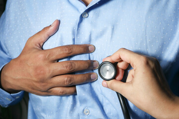 Doctor using a stethoscope checking body, close up
