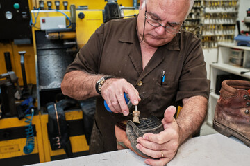 shoemaker man working in his shoe shop
