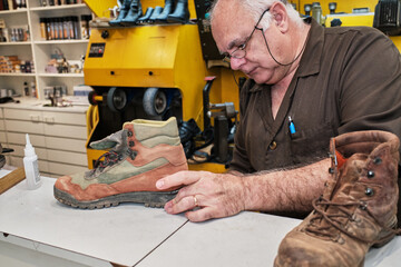 shoemaker man working in his shoe shop