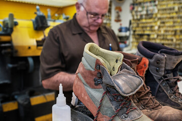shoemaker man working in his shoe shop