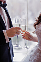 Bride and groom holding champagne glasses