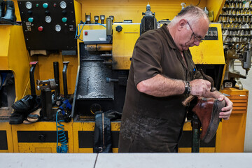 shoemaker man working in his shoe shop