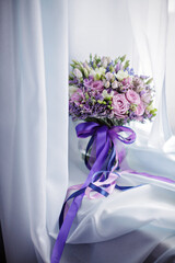 Purple Bridal bouquet decorated with ribbons