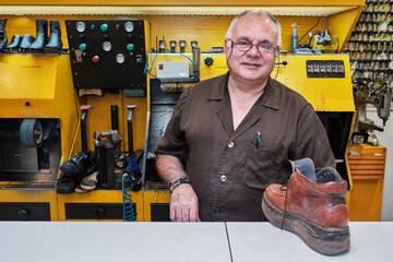 shoemaker man working in his shoe shop