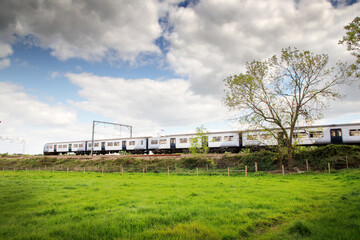 Fototapeta na wymiar train zooming by in a landscape image