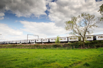 Fototapeta na wymiar train zooming by in a landscape image