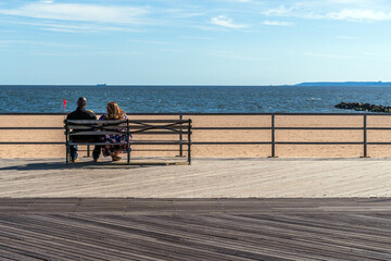 Fototapeta na wymiar Coney Island, New York, USA. February, 2017. Couple enjoying the view of the beach