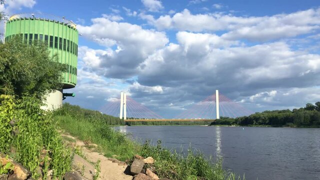 Panoramic view of wisla vistula river in warsaw poland with the siekierkowski bridge in the background on a cloudy day