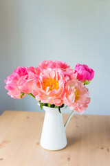 Vase with bouquet of beautiful pink peonies on table in room, close-up. Bloom. Peony. 