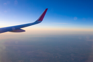 Naklejka na ściany i meble Ground and horizon at sunset from an airplane