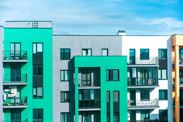 Facade of the building colored in Irish flag color. New residential apartment. Modern . Architecture. Balcony. Urban. Stylish. Low-rise buildings. Complex. Development