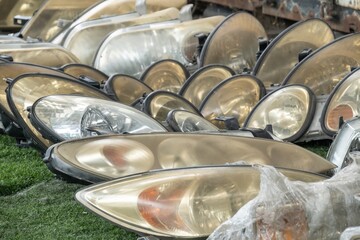 Used headlamp components for sale at scrapyard area