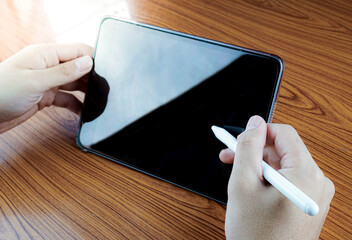 man using tablet with stylus pen