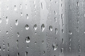 Macro photography of water drops on glass window white background after the rain