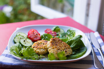 Delicious Homemade Meatballs or Vegetarian Cutlets, Fresh Vegetables and Green Herbs are Served Against Background of Open Window to Beautiful Garden. Summer menu.