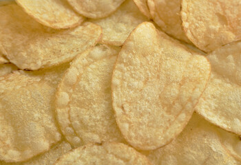 Crispy potato chips close-up, background, small sharpness depth