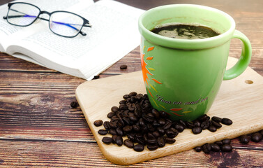 green cup of coffee and beans 