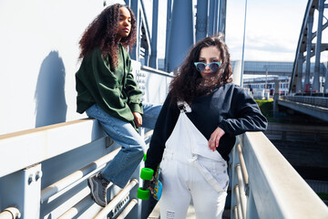 Naklejka premium young cute teenage girls together in industrial zone happy smiling having fun, big city lifestyle fashion people