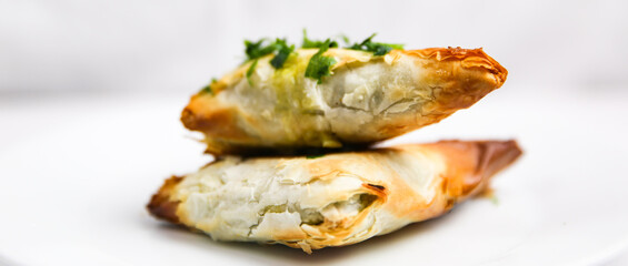 Handmade Greek Spinach and Feta Cheese Phyllo Spanakopita on white plate