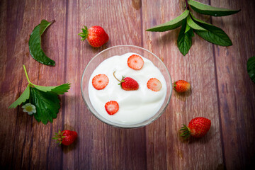 sweet homemade yogurt with red ripe fresh strawberries