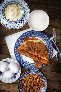 Keto diet almond crapes on fancy plates and wooden background.