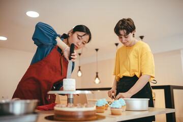An Asian baker and a Caucasian baker making a mini cheesecake