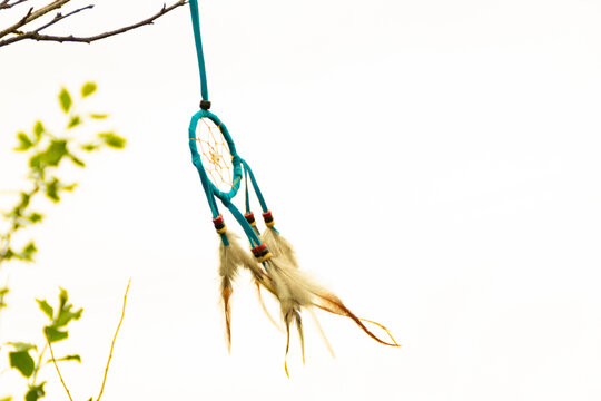 Dream catcher close-up on a white sky background. Blurred background.