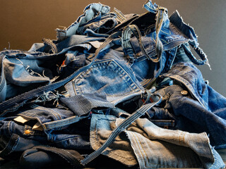 Pile of old blue jeans ready for recycling in the circular economy.  Room for text.