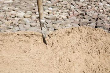 Shovel for scoop sand in construction work, sand material and stones. Building materials for construction work.