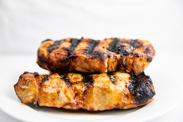 Classic grilled marinated pork chop on white plate