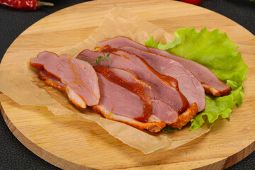 Sliced smoked duck breast served salad
