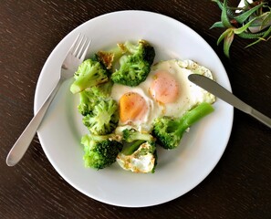 Fried eggs with broccoli, top view